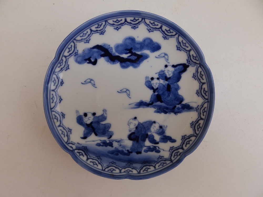 A small Oriental blue & white porcelain dish decorated with boys at play, 5.4" diameter.
