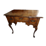 An early 18thC walnut veneered lowboy with banded top, re-entrant front corners, three drawers to