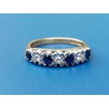 A seven stone sapphire & diamond set 18ct gold ring. Finger size M/N.