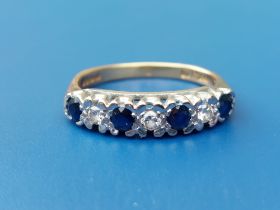 A seven stone sapphire & diamond set 18ct gold ring. Finger size M/N.