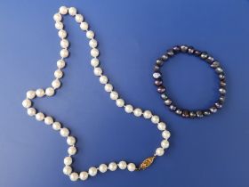 A 16.5" pearl necklace with Birmingham 9ct gold clasp and one other. (2)