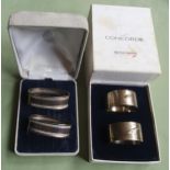 A pair of silver 'Concorde' napkin rings and one other pair. (4)