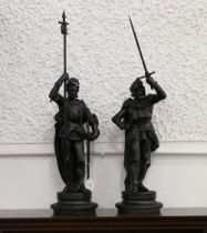 Pair of black cast metal knight sculptures,