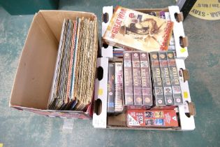 Two boxes of VHS video cassettes and vinyl LPs