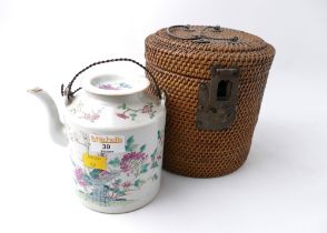 Oriental ceramic teapot in wicker basket