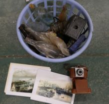 Basket of vintage bottles, cameras, prints,