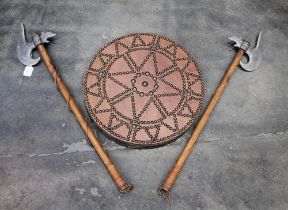 Two reproduction ornamental axes and leather and studded shield