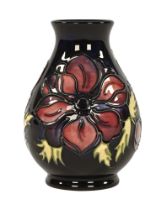 A Moorcroft anemone patterned vase, with various painted and impressed marks to the bottom.