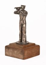 A plated metal car mascot, in the form of a sailor with telescope and raised on an oak plinth.