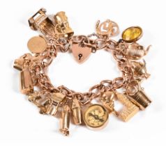 A 9 ct gold charm bracelet, all charms hallmarked except for one.