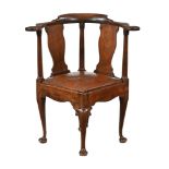 An early 19th century mahogany corner armchair,