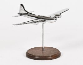 An Art Deco chrome model of a vintage aeroplane, raised on a wooden base. Plane length 19.