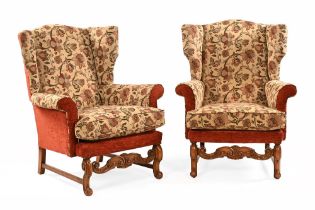 A pair of walnut wing easy chairs, in the Queen Anne style with upholstered back, wings,