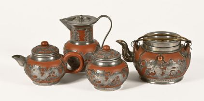 An early 20th century Chinese four piece Yixing clay-red terracotta tea set,