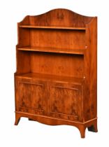 A reproduction George III style yew wood waterfall bookcase,