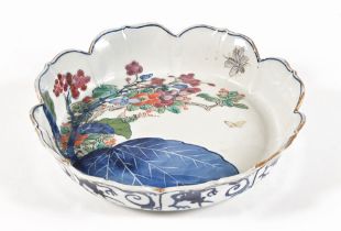 An oriental dish with shaped edge, decorated with flowers, foliage and butterfly.