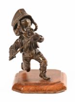 A Victorian bronze Vesta striker, in the form of a young boy with sabre and bugle.