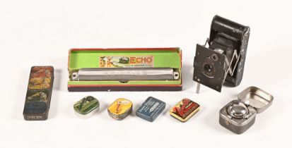 A boxed Hohner Echo mouth organ, a Vest Pocket Kodak folding camera, a travel inkwell in metal case,
