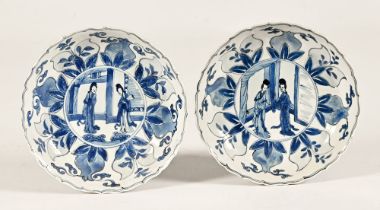 A pair of Chinese blue and white dishes, decorated to the centre with a pair of female figures,