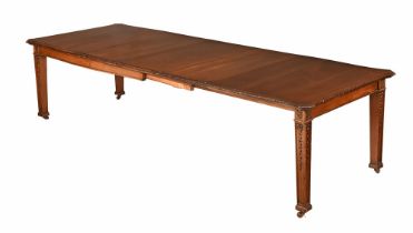 An Edwardian mahogany Waring and Gillow extending dining table with wind out action and three