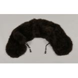 An Ostrich feather stole, black with rope and toggle tie, early 20th century.