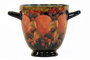 William Moorcroft a pomegranate two handled vase, with signature to the base,