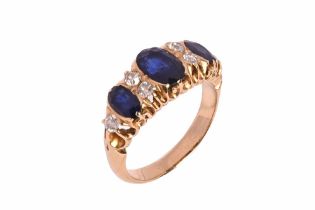 A yellow metal ring with three sapphires, flanked by six diamonds. Weight 5.7 grams. Size N.