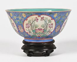 A Chinese bowl, with turquoise blue interior and blue exterior with four floral panels,