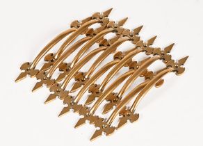 A set of twelve Victorian brass handles. Length 18 cm (see illustration).