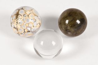 Three spherical mineral specimens, one rock crystal,