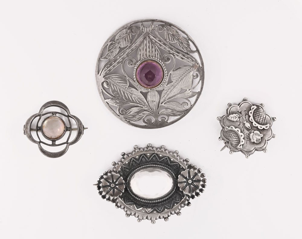 A Scottish 925 circular brooch, with amethyst coloured stone, a silver brooch from S.B.