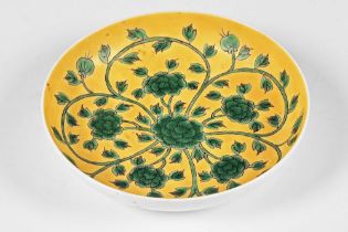 An antique yellow dish, decorated with flowers and having a six character mark to the rear.