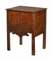 A Georgian mahogany commode, with cupboard above the sliding commode drawer with brass drop handle.