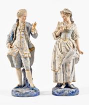 A pair of continental bisque figures, lady and gentleman both with green anchor mark to the base.
