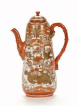 A large Japanese Kutani wine pot, the body decorated with pheasants and with faux bamboo handle.