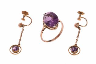 A yellow metal ring with amethyst coloured stone,