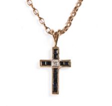 A 9 ct gold sapphire and diamond cross, with 9 ct gold chain. Gross weight 6.2 grams.
