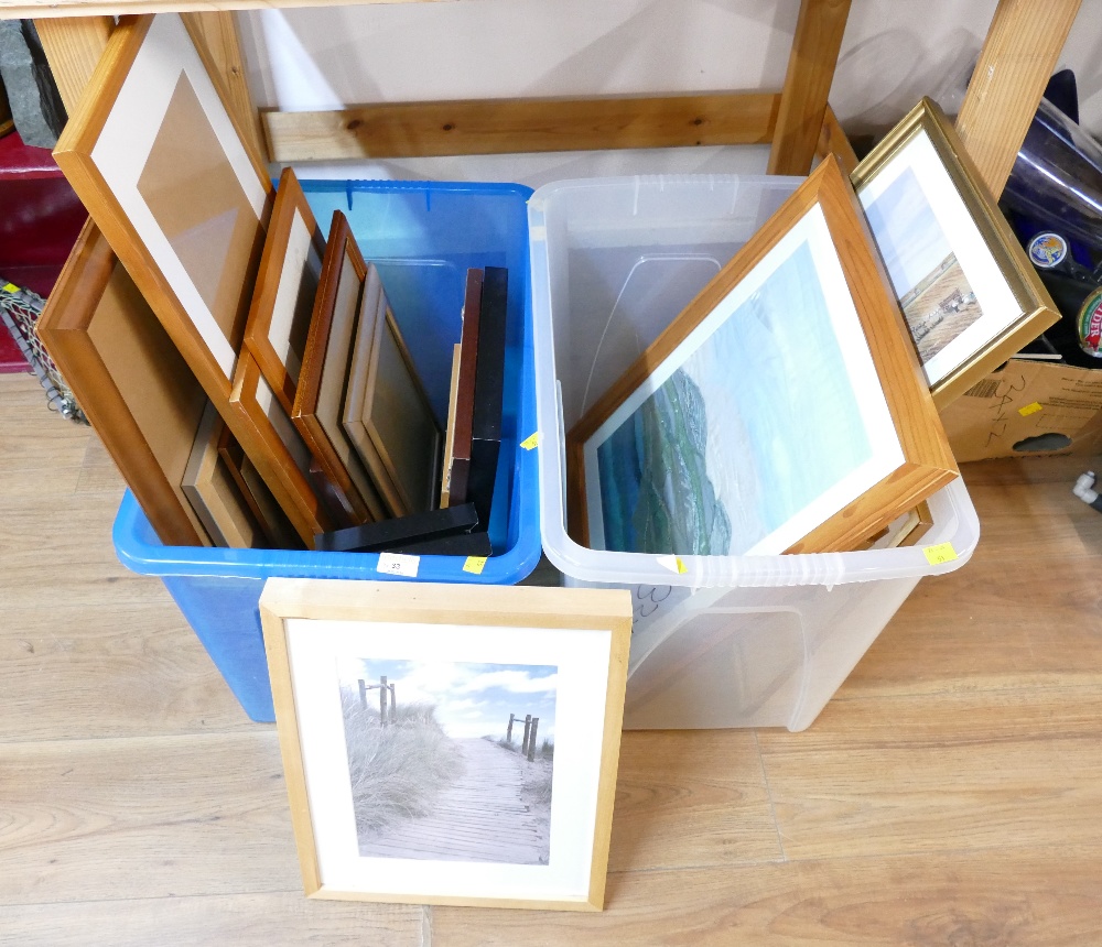 Two boxes of empty picture frames and pictures and prints