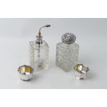 Two cut glass dressing table perfume bottles with silver caps, and pair of silver trinket pots,