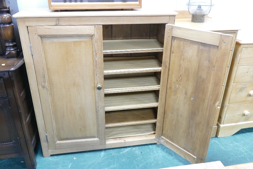 Freestanding pine cupboard with internal shelves, height 114 cm, width 106 cm,