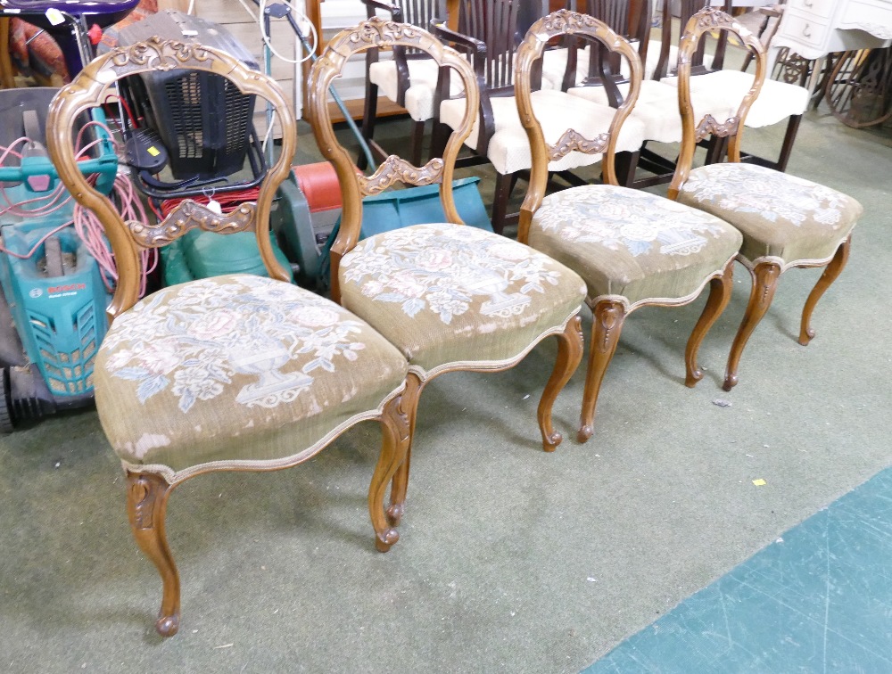 A set of four Victorian salon / dining chairs having ornate scroll foliate balloon backs,