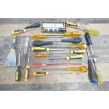 Yellow bucket containing various screwdrivers.