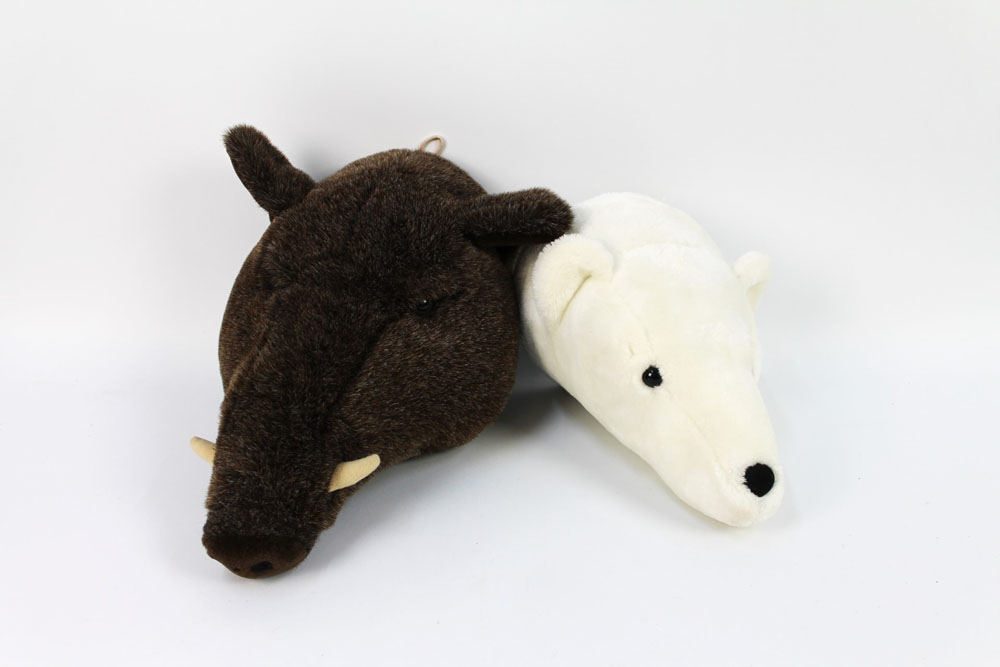 Two soft toy animal heads, the first a wild boar protruding from the wall +/- 30 cm,