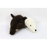 Two soft toy animal heads, the first a wild boar protruding from the wall +/- 30 cm,