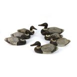 Seven late 20th century wooden duck decoys, in two different sizes, the largest beak to tail 37 cm,