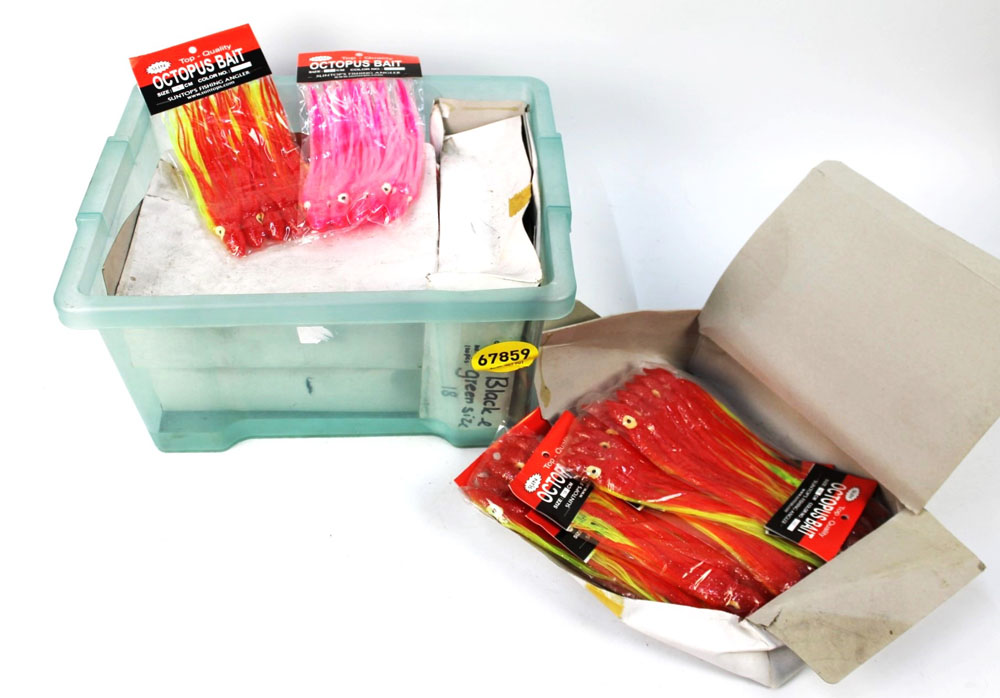 Four boxes of Octopus bait sea fishing lures.