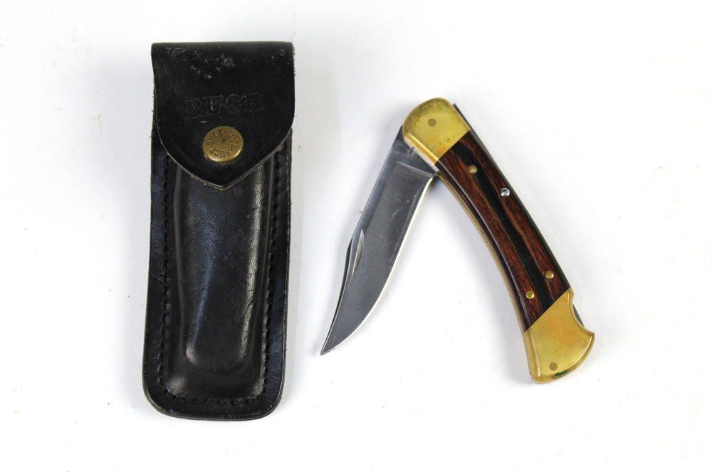 A buck 110 folding pocketknife, with a 3 3/4" blade, 22 cm overall with leather pouch.