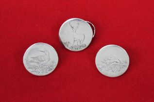 Three silver coloured buttons, engraved to front with a stag, woodcock and hare.