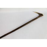 A hazel shafted walking stick with a red stag antler handle. Overall length 123 cm.