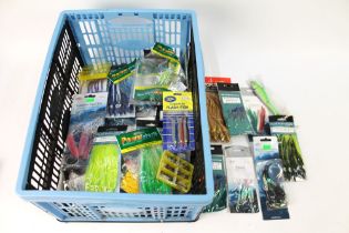 A plastic box containing a large quantity of sea fishing lures, feathers, hooks etc.